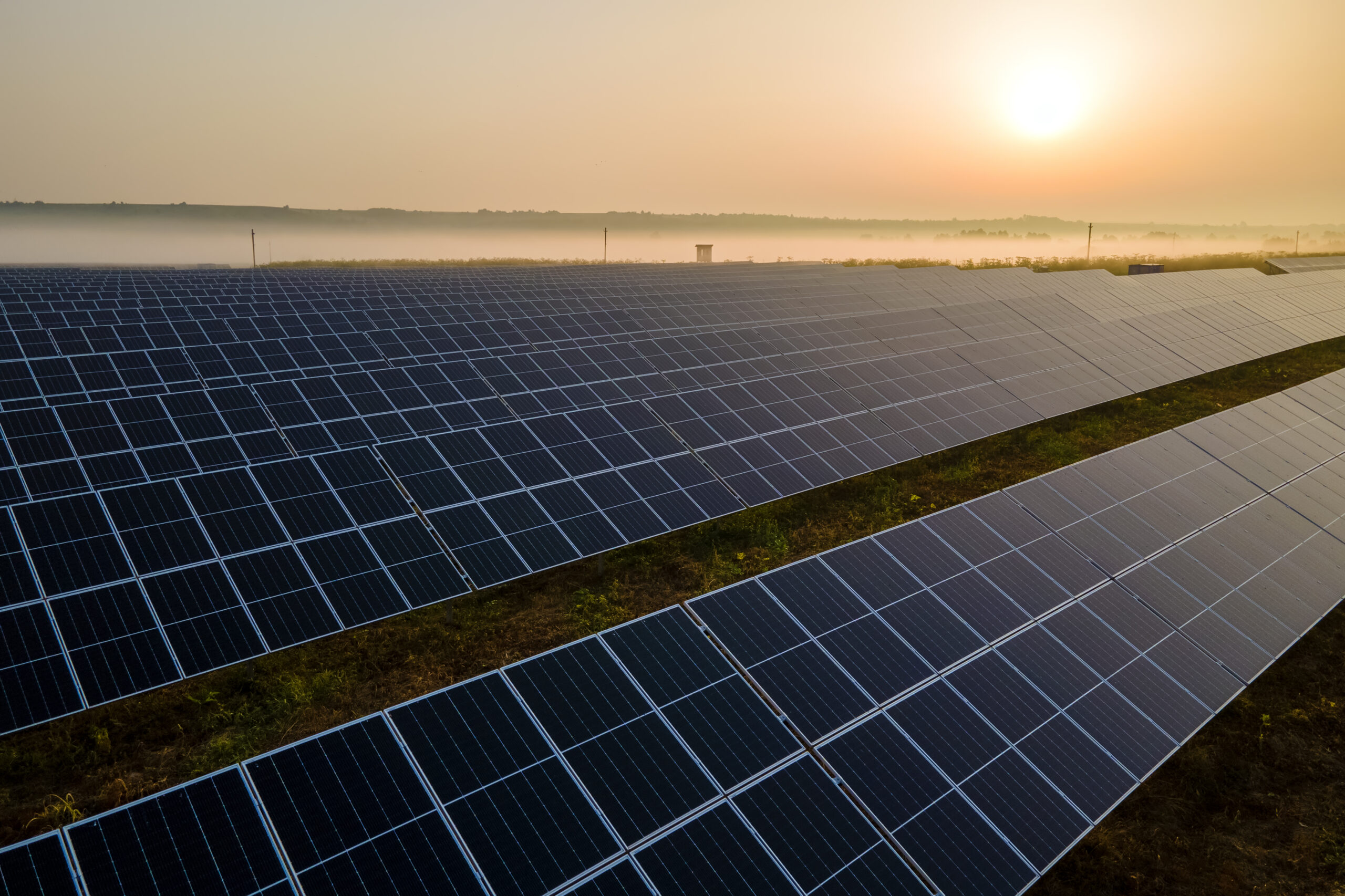 Aerial view of large sustainable electrical power plant with rows of solar photovoltaic panels for producing clean electric energy in evening. Concept of renewable electricity with zero emission abertura do mercado livre de energia no Brasil